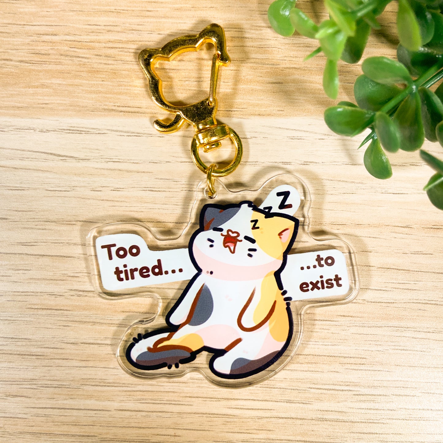 Tired calico cat acrylic charm