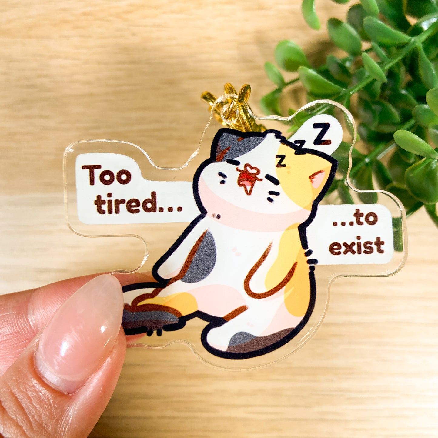 Tired calico cat acrylic charm